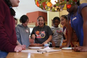Time to cut the cake: joyous bakers enjoy their creation...