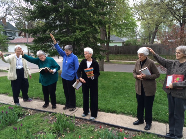 Processing out singing "Canticle of the Sun" and the Garden Blessing: S. Katherine tossing earth, S. Suzanne reading the prayer